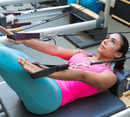 A woman works out on a fitness machine
